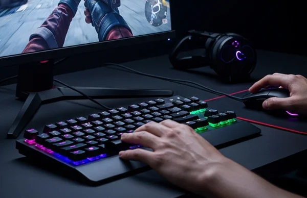 Gaming setup with low latency monitor, mouse, and keyboard.